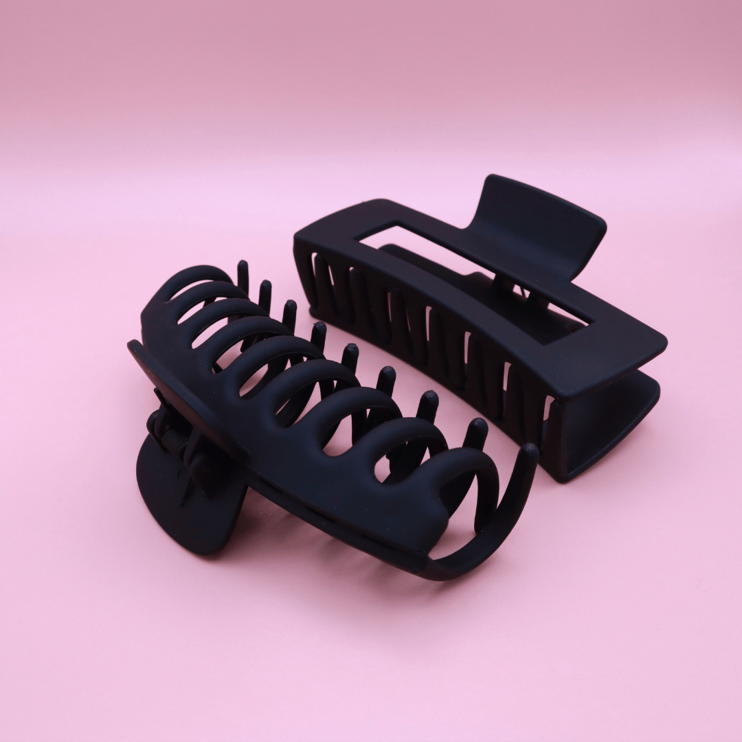 Set of black matte plastic hair claw clips on a pink background, Haarklammern Set