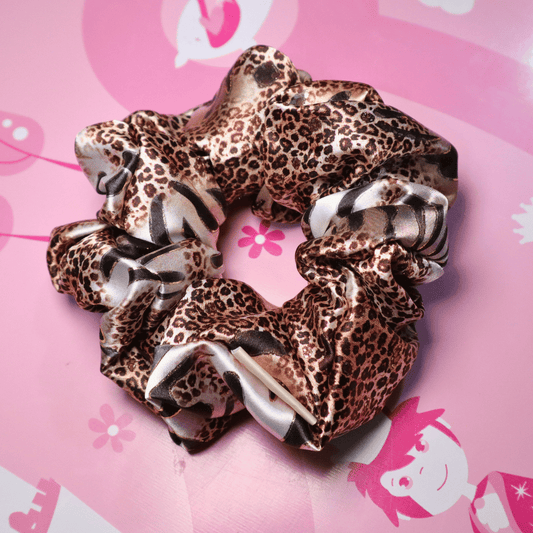 Leopard print satin scrunchie with black and brown pattern, eco-friendly handcrafted accessory.