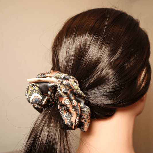 Scrunchie in Salbeifarben mit Paisley-Muster im Haar, haarschonend und stilvoll.