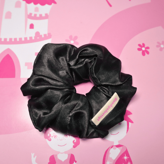 Elegant black scrunchie made of satin, eco-friendly and hand-crafted for gentle hair care.