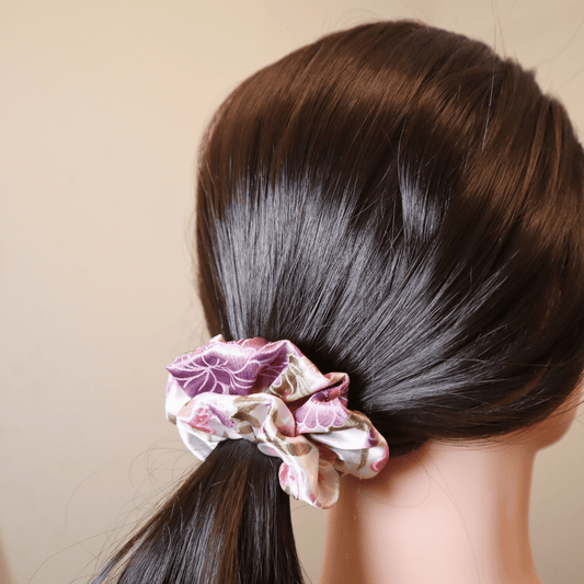 Flora Dream scrunchie in floral pattern, providing gentle hold without hair damage.