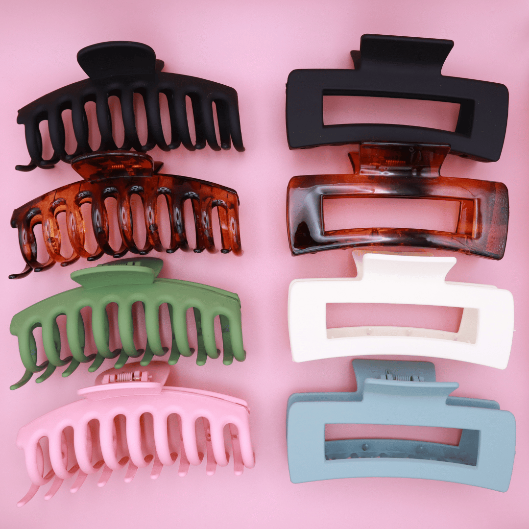 Set of 8 pastel-colored Haarklammern hair clips in brown, green, black, blue, pink, and white with matte finish and strong grip on pink background