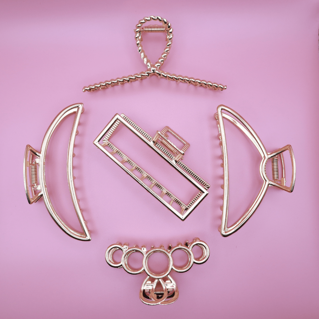 Golden Belle Signature Claw Clip Set with five elegant gold metal hair clips on pink background