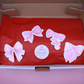 Golden Belle Signature Claw Clip Set packaged with decorative pink bow stickers on red wrapping paper in a cardboard box